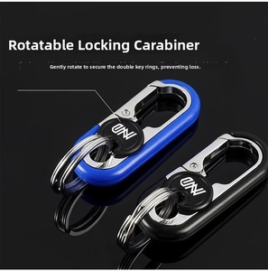 Close-up of black and blue business car keychains with dual rings on a reflective surface