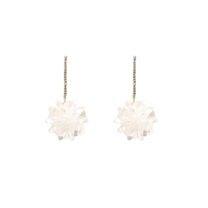 Detail of elegant white shell flower earrings with long gold tassel and sparkling zircons