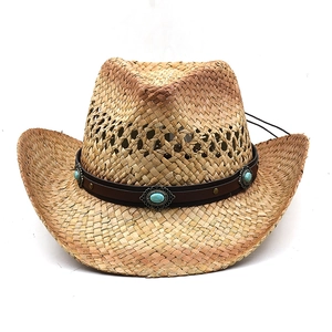 Detail of hand-woven western cowboy hat with leather band and turquoise stone buckle