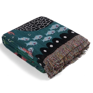Detail of bohemian jacquard woven blanket showing thick knit texture and colorful tassels