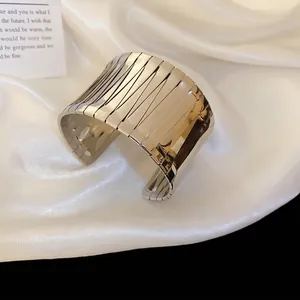 Minimalist irregular wide open bangle in polished silver finish on silk fabric
