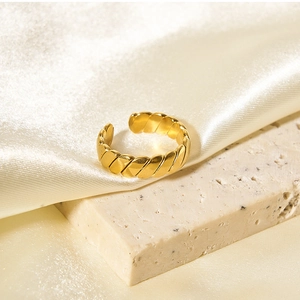 Macro shot of gold twisted rope texture on a minimalist adjustable titanium steel ring