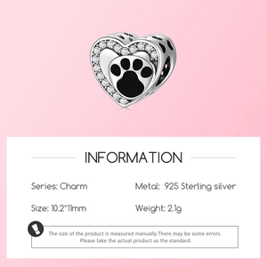 Macro shot of 925 sterling silver heart charm with black paw print and white zircon stones