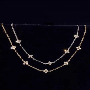 Macro detail of gold and silver flower necklaces featuring micro-inlaid cubic zirconia
