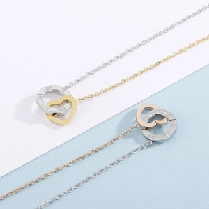 Titanium steel necklace with interlocking diamond-encrusted circle and heart pendant
