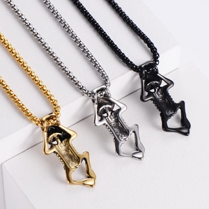 Three skeleton body pendants in gold, silver and black colors on white podiums