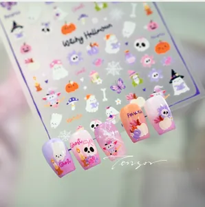 Detailed view of Halloween nail stickers featuring ghost, pumpkin and witch designs