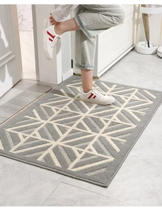 Detail of Nordic grey entrance mat with white geometric lines and tufted texture