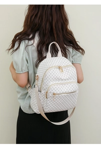 Detailed back view of a white waterproof backpack featuring grey geometric print and gold zippers