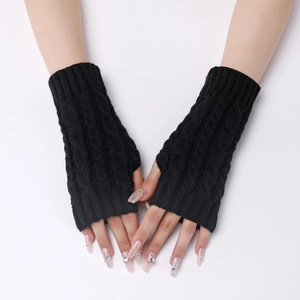Close-up of black cable knit arm warmer showing textured knit detail and fingerless design