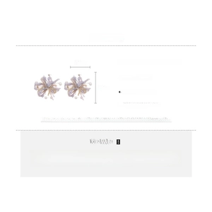 Detail showing wool flower pendant and imitation pearl earrings with silver needles