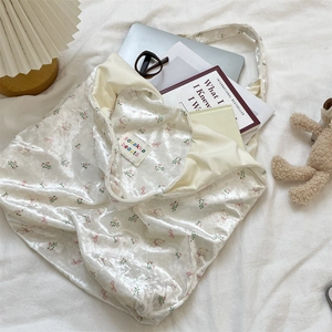 Detailed view of the pearlescent cream tote bag with bear print showing large capacity