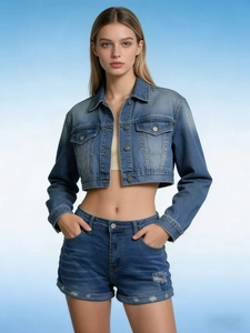 Detail of light blue denim set featuring a cropped jacket and ripped tassel shorts