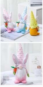 Close-up of three colorful Easter faceless gnomes with bunny ears and carrots