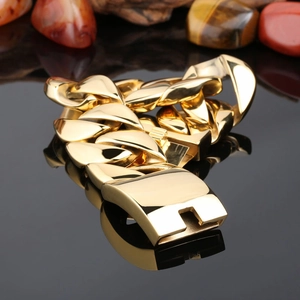 Men's bold gold-plated titanium steel Cuban chain bracelet on black reflective surface