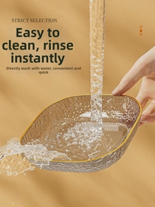 Close-up of hammer textured fruit plate being washed under water to show easy cleaning