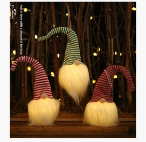 Gnomes de Noël lumineux avec lumières LED et chapeaux tricotés rayés dans un décor de forêt