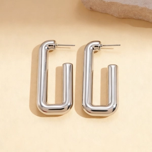 Detail of silver rectangular U-shaped metal earrings with a polished glossy finish
