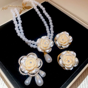 Détail de la parure bijoux fleur et perle avec collier, broche et boucles d'oreilles