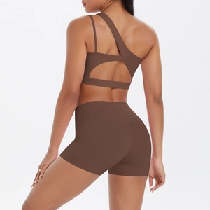 Detail view of coffee brown single shoulder sports set with open back yoga bra and shorts