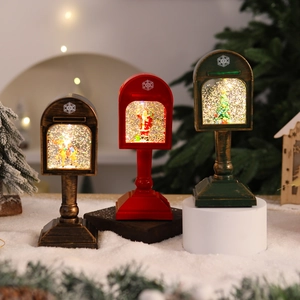 Detailed view of three vintage Christmas mailbox snow globes with festive figurines