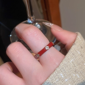 Detail of 14k gold plated ring with red enamel finish and square-cut zircon stones
