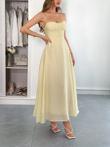 Detail view of light yellow slip maxi dress with pleated bust and corset style boning