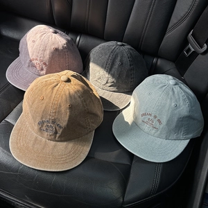 Detailed embroidery on vintage washed canvas baseball caps in multiple colors