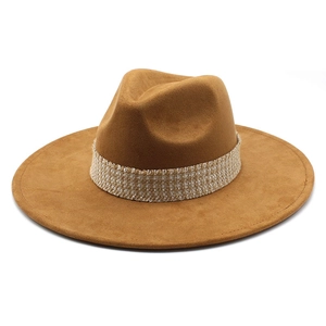 Close-up of khaki faux suede fedora hat featuring an intricate woven decorative band detail