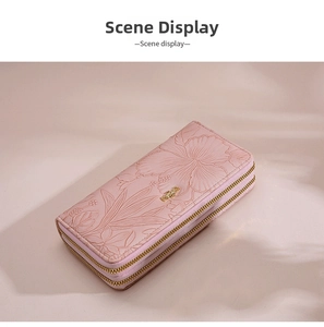 Detail view of pink long wallet with floral embossing and double zipper design