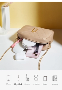 Macro view of beige quilted bag interior showing capacity for smartphone and cosmetics