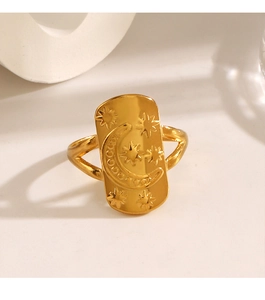 Macro shot of gold celestial ring featuring engraved moon and star rectangle plate