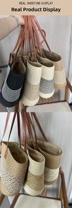 Detail of woven beach tote bags with leather handles and contrast stitching accents