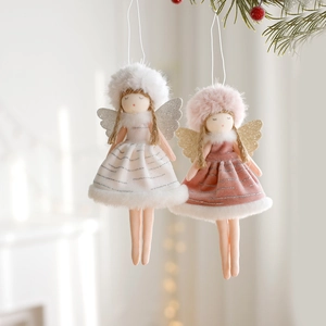 Christmas plush angel ornaments with sequin wings on a tree, white and pink colors