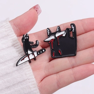 Black cat enamel pins featuring skeletal motifs and knife graphics in dark humor style