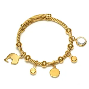 Golden 18K steel cable bracelet with dolphin, round charms and crystal stone charm