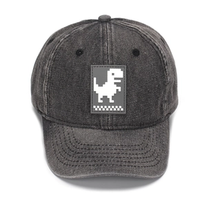 Close-up of vintage grey denim baseball cap featuring white pixel dinosaur patch detail