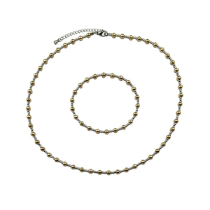 Detail of gold and silver beaded jewelry set with lobster clasp and extension chain