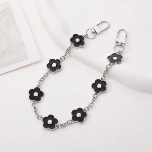 Detail of silver metal chain with black plum blossom charms and swivel lobster clasps