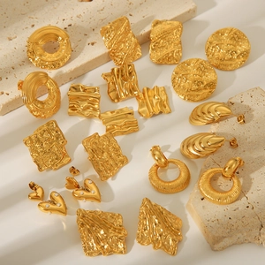 Golden 18K plated stainless steel geometric earrings set on stone textured background