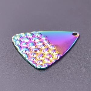 Detailed view of rainbow textured stainless steel triangle charm with hammered finish
