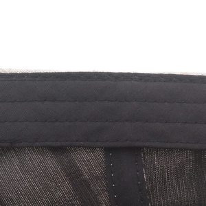 Detail of internal black sweatband and stitching on the cotton plaid newsboy hat
