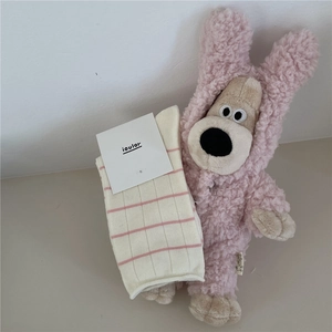 Detail of off-white and pink striped cotton crew socks with fine ribbed texture
