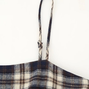 Women's plaid camisole with layered ruffles and thin shoulder straps in a checkered pattern