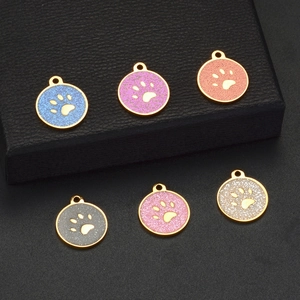 Detailed macro view of colorful glitter paw print charms in various vibrant shades