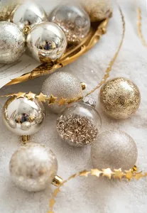 Close-up of luxury 6cm Christmas ball ornaments in gold and white on a decorative tray