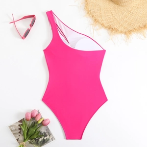 Magenta one-shoulder swimsuit with side cutout and removable pads on a white background