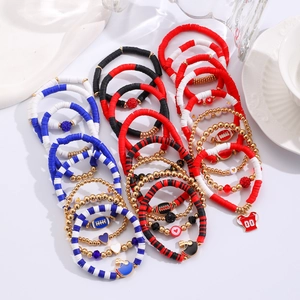 Detail of multi-layer Gameday clay bead bracelets with American football charms and beads