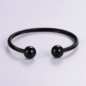 Minimalist black twisted cable open bangle featuring symmetric metal bead finials