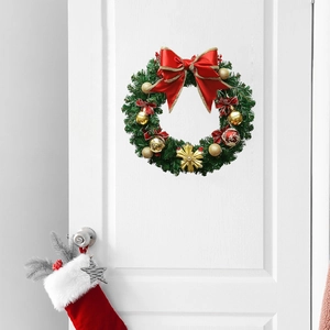 Christmas wreath with red bow and gold baubles hanging on a white wooden door decor